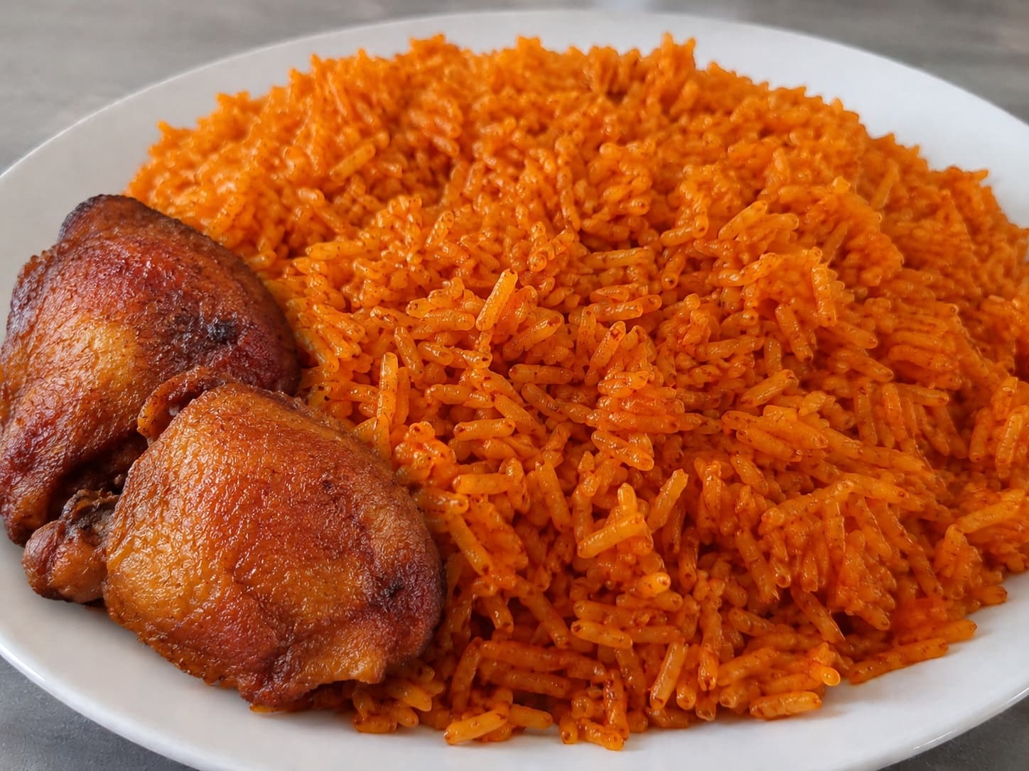 Smoky Nigerian jollof rice with grilled chicken
