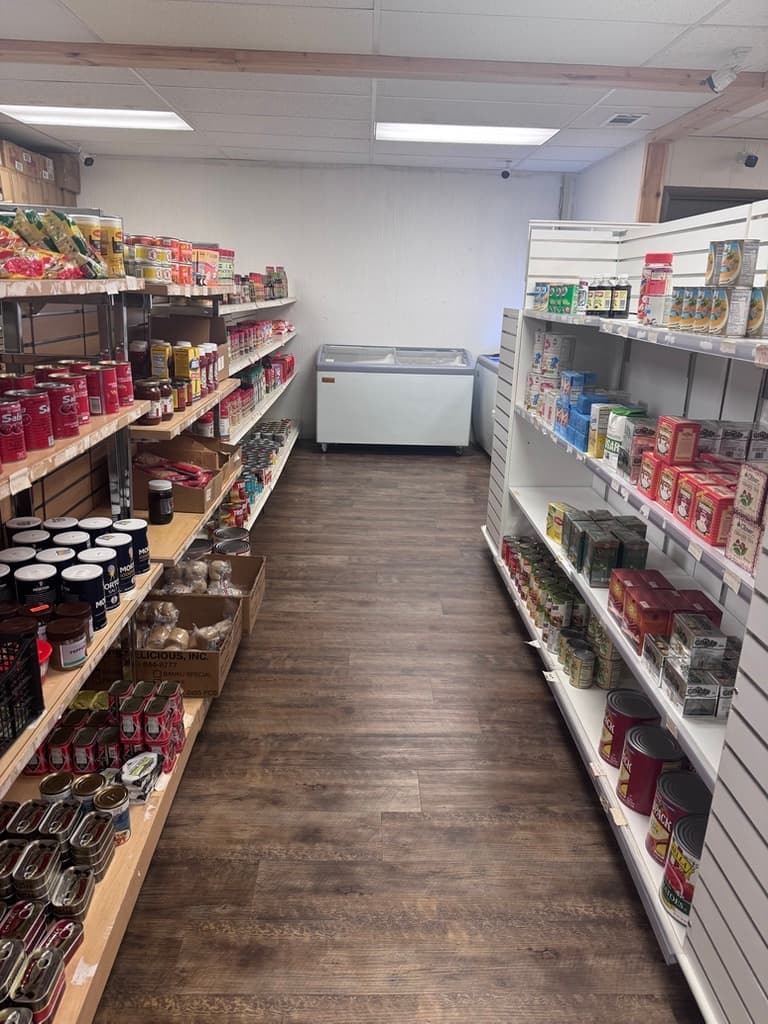 Aisle of canned goods and pantry staples inside the African Caribbean food market