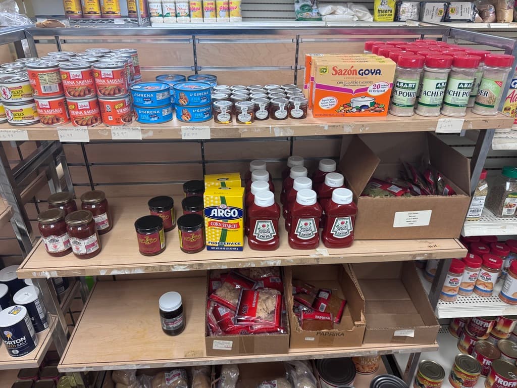 Canned goods, Sazón and pantry staples on the shelf
